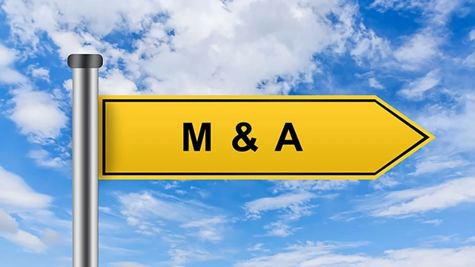 yellow sign with black letters M&A printed on it infront of blue cloudy sky 