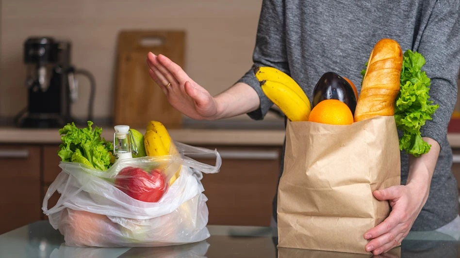 person saying no to plastic bag in favor of paper