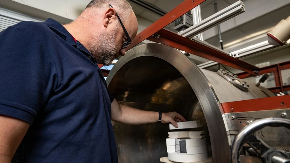 Man in blue shirt working in lab