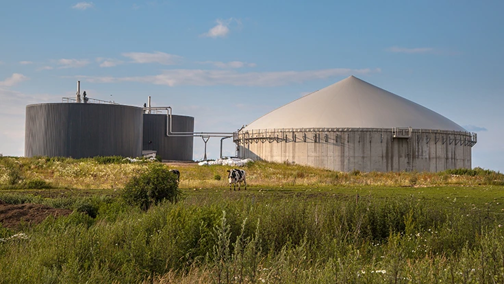 anaerobic digestion facility in a field under sunny skies