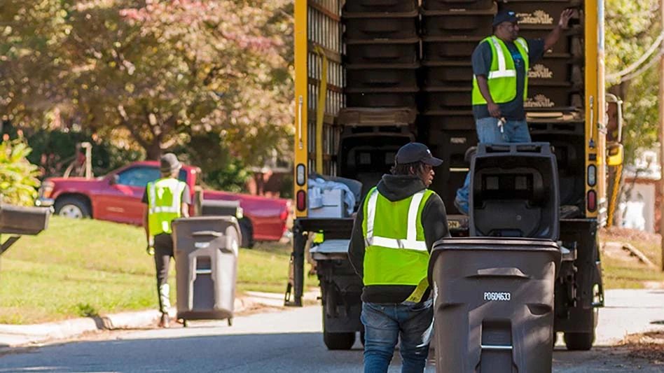 Men collecting collection carts from a enighborhood