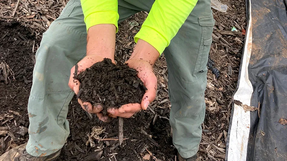 man holding finished compost in hands