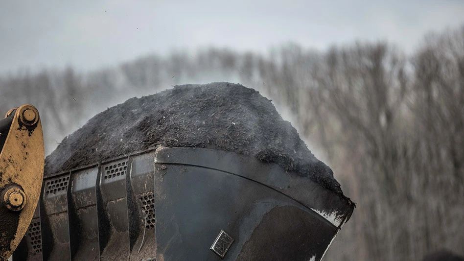 a loader bucket full of compost