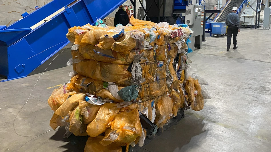 A bale of Hefty ReNew orange bags sits at a MRF.