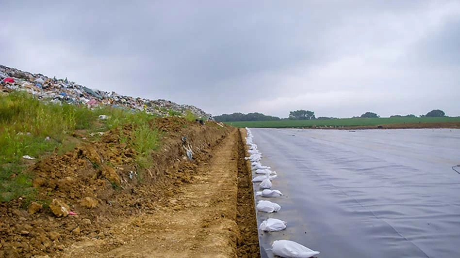 black landfill liner with sandbags on edge