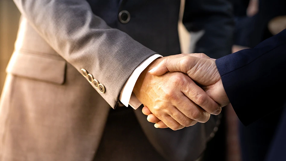 two men in suits shaking hands