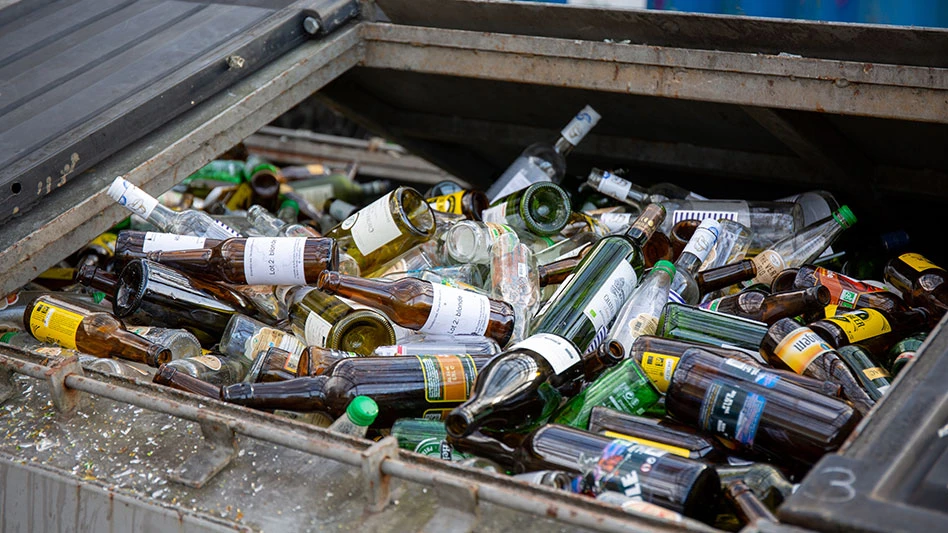 a container filled with differnt colored glass bottles