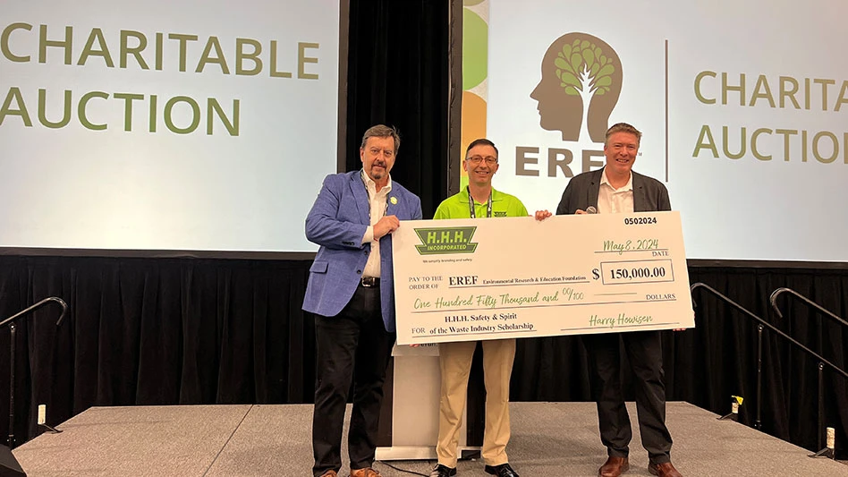 photo of three white men holding an oversized check