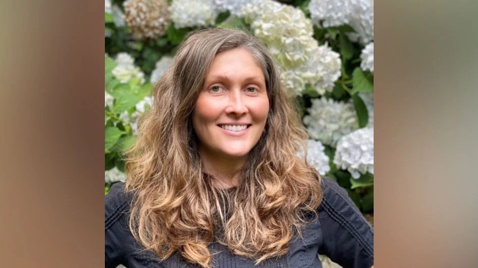 a smiling woman with light brown hair