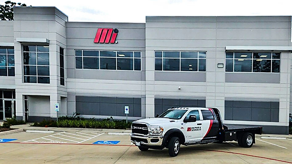 a truck with the Motion Industries logo parked in front of a building with the same