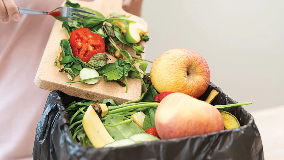 food scraps being placed in a collection bin