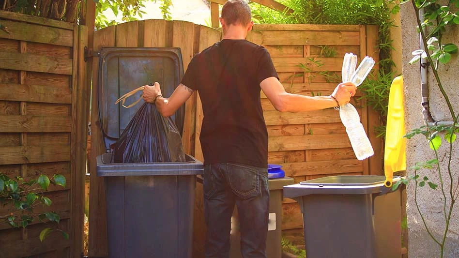 man sorting waste from recyclables