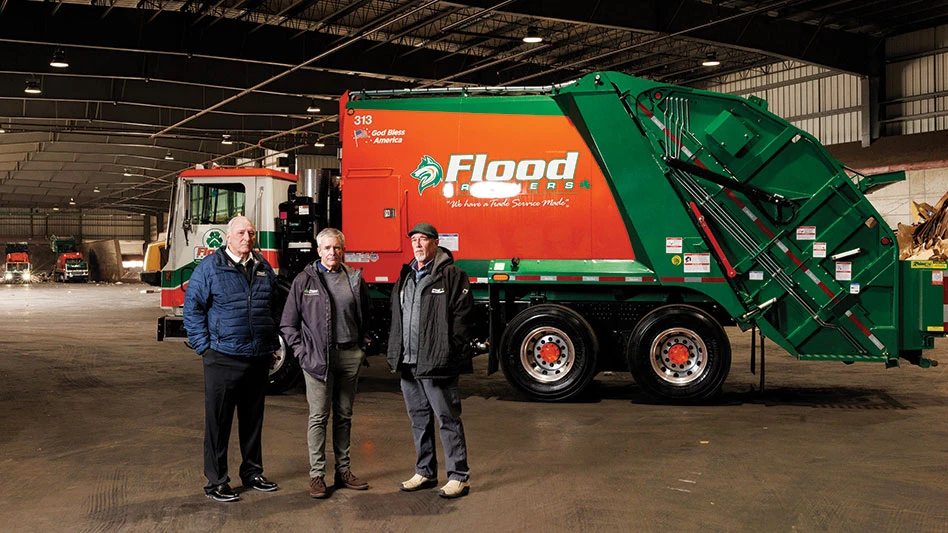 flood bros partners standing in front of collection truck