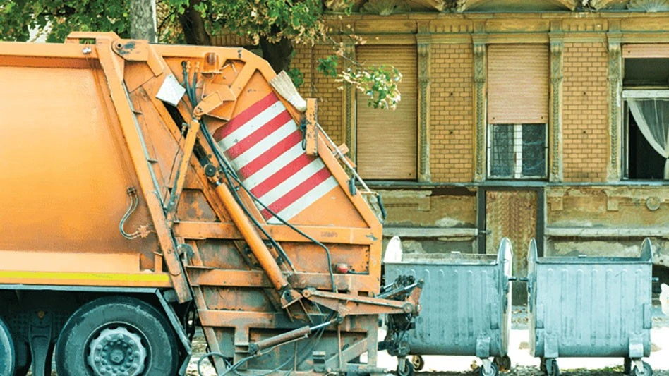 garbage truck and containers at curb