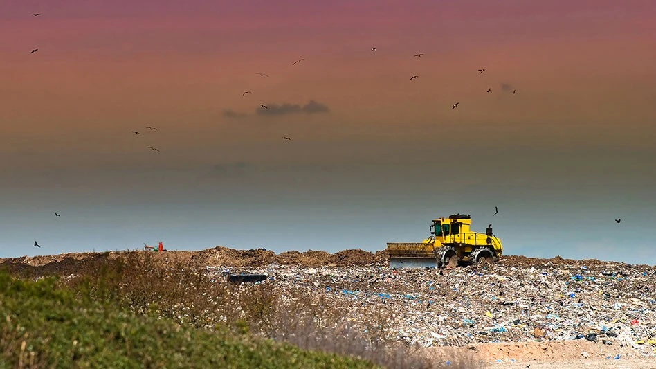 Landfill compactor against with sunset